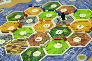 Settlers of Catan opened the mind of many Americans to European style board games, which feature streamlined rule systems that required much more thought and player cooperation than American games of the time. 