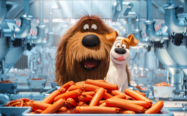 Duke (Eric Stonestreet) and Max (Louis C.K.) find themselves in doggy heaven AKA a sausage factory. Photo Courtesy of Illumination Entertainment. 
